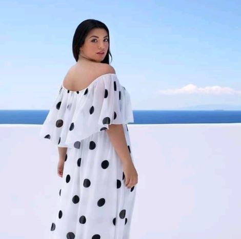 Γυναίκα με μακρύ λευκό φόρεμα με μαύρες χάντρες